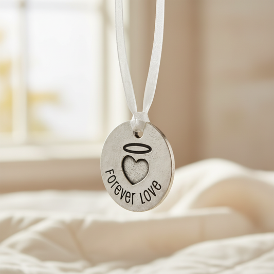 Forever Love charm hanging from ribbon