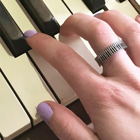person playing the piano wearing a piano ring