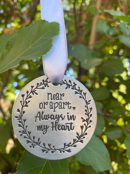 Collect and Cherish Beautiful Moments Holiday Ornament back hanging in a tree
