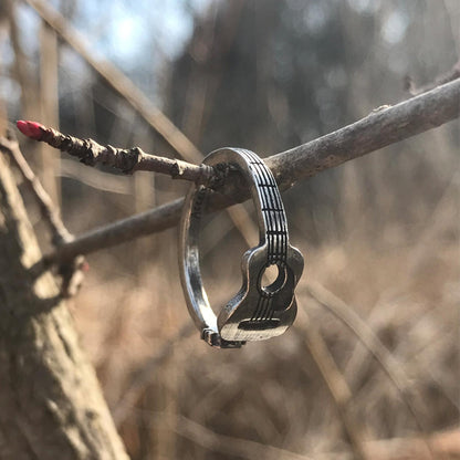 Guitar Player Inspire Ring hanging on tree branch