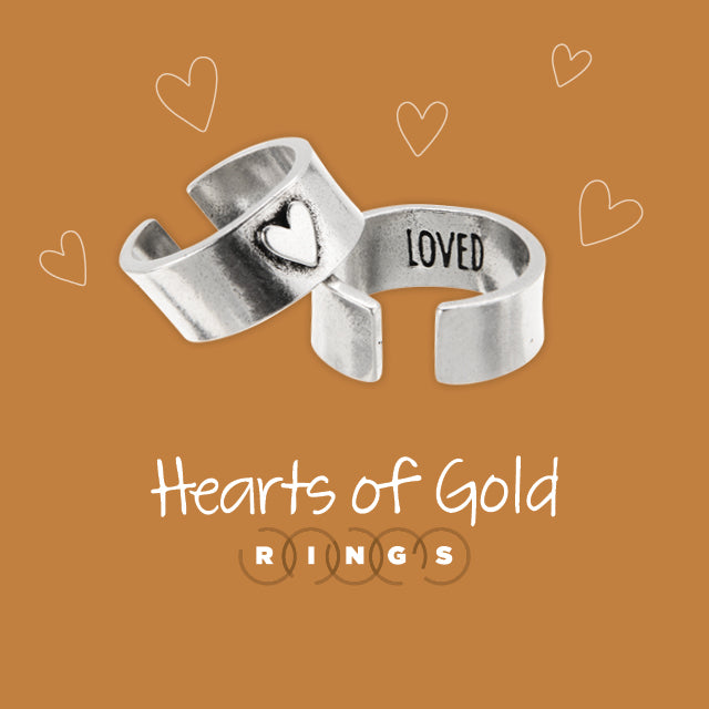 Hearts of gold rings on brown hearted background