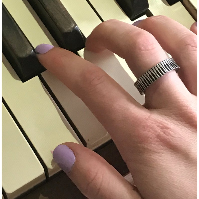 Person playing the piano wearing a Piano Inspire Ring
