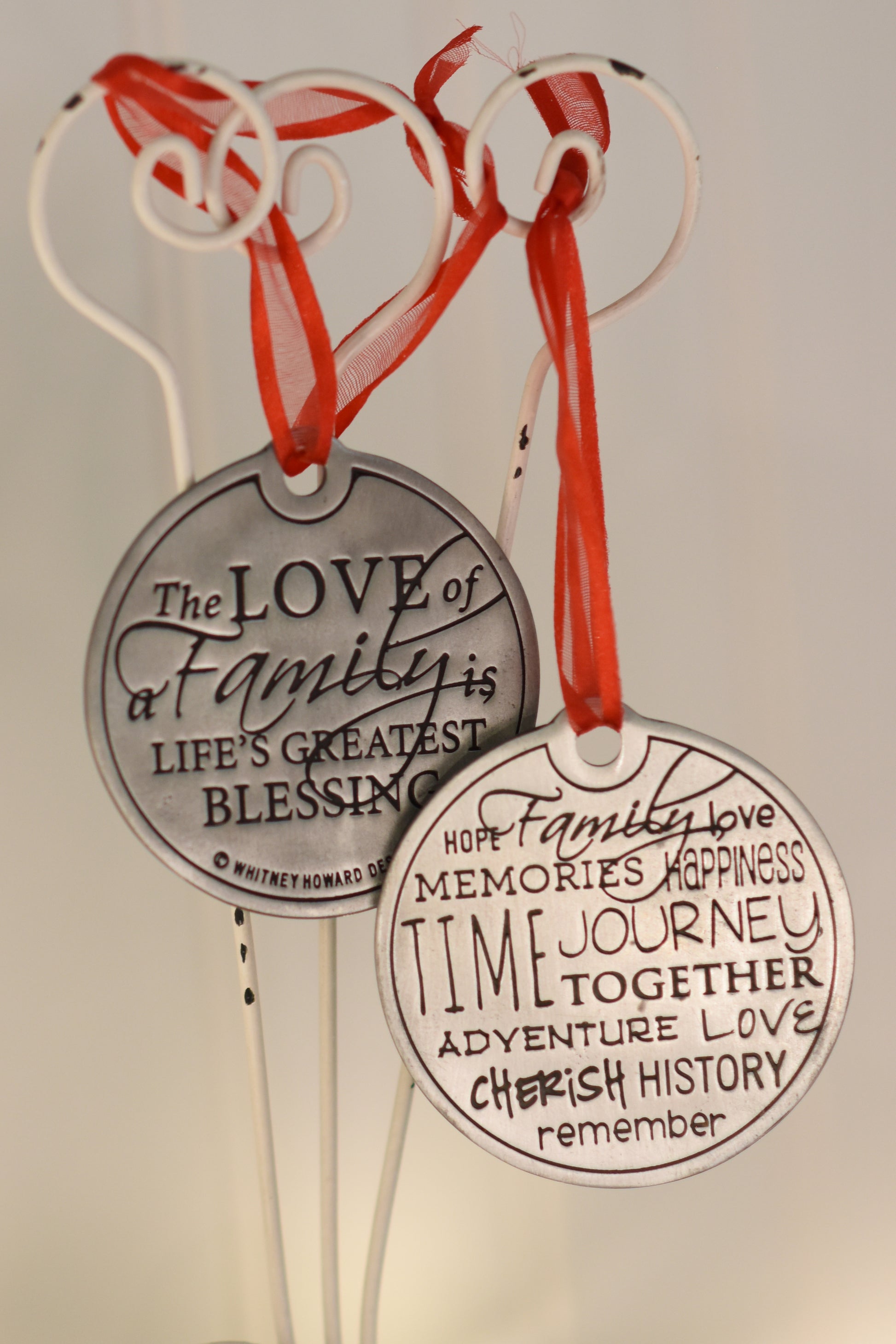The Love of a Family is Life's Greatest Blessing Holiday Ornament front and back hanging on wire pole