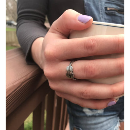 Violin Player Inspire Ring on finger holding coffee cup
